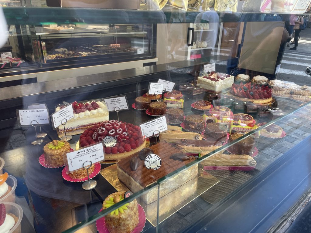 Ernest patisserie window in Cannes with raspberry and strawberry tarts, eclairs and chocolate cakes
