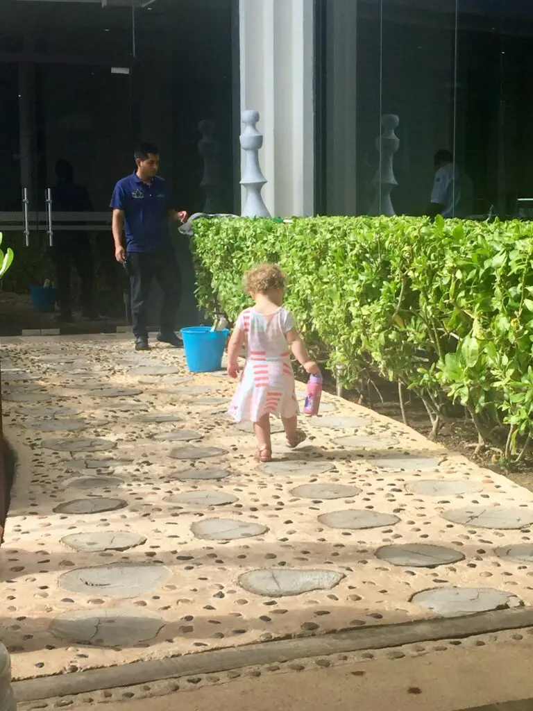 toddler walking down path at resort