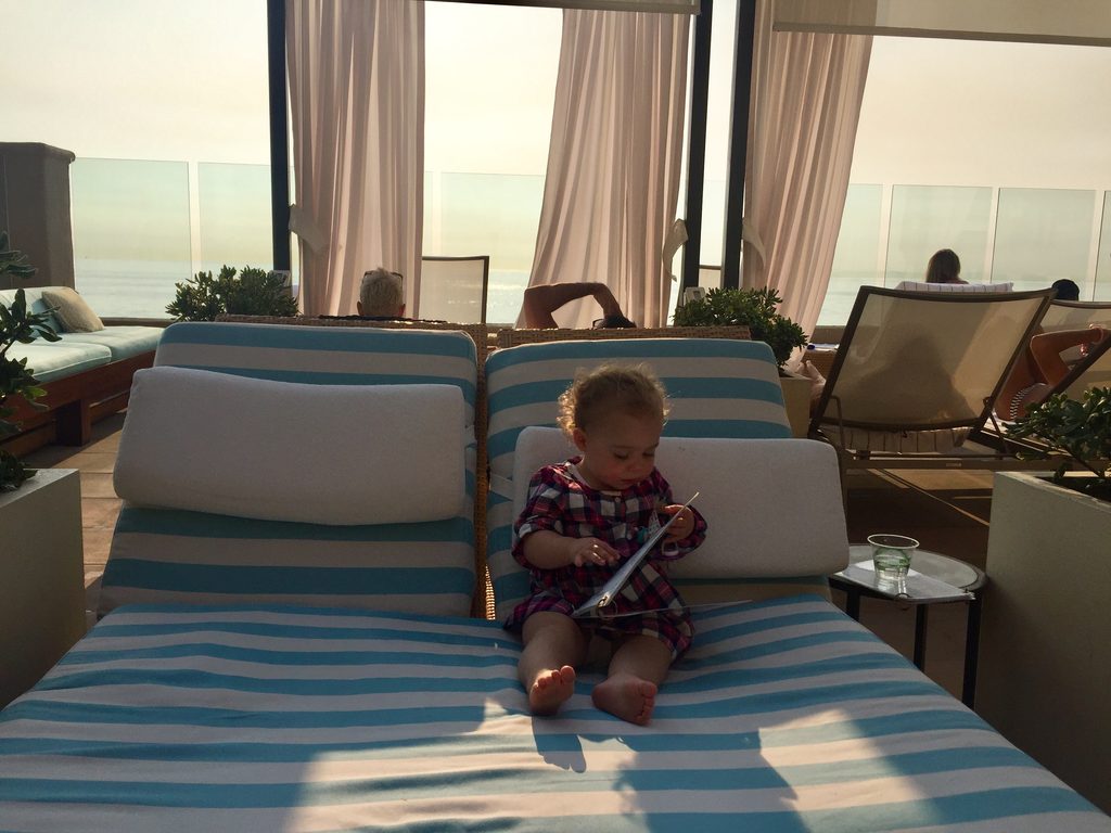 toddler browsing the pool service menu